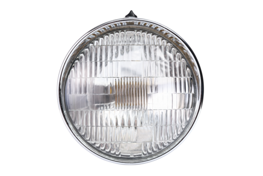 Old vintage motorcycle headlight isolated on white background.