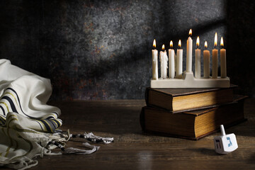 Jewish religious holiday Hanukkah with holiday Hanukkah, dreidel and Taillight on a dark background