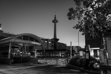 a tall clock tower in the background with a walkway next to it