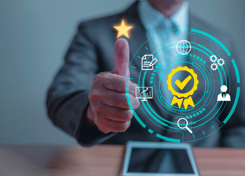 Business man thump up with the star and sign of the top service Quality assurance, Guarantee, Standards, ISO certification and standardization concept, satisfaction, service experience