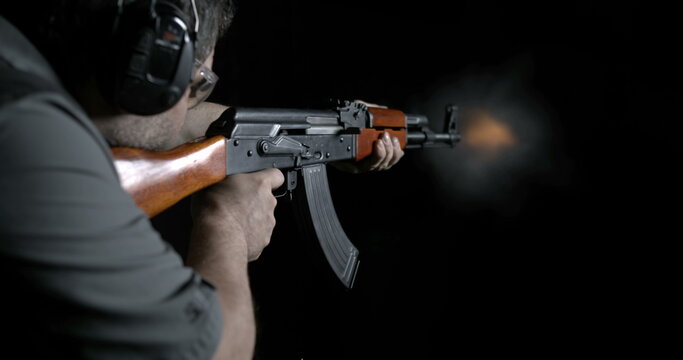 Shooting Kalashnikov weapon at highs-speed 800 fps slow-motion. Person aiming and firing AK-47 Rifle. Gun speed-ramp
