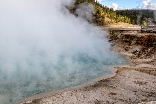 excelsior geyser crater, a dormant geyser and steaming hot spring on a cold cloudy day and letting off huge amounts of steam in Yellowstone national park