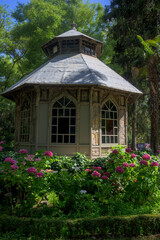 Cork chalet house in the gardens of the royal palace of Madrid in the Campo del Moro vertically with flowers in the foreground