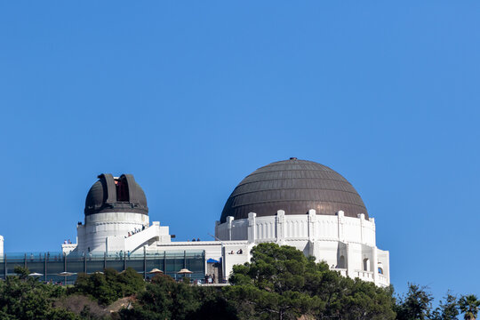 a view of the griffith observatory from a nearby hill, image shows the los angeles observatory built in 1933 on a clear sunny day and open to the public, taken october 2023