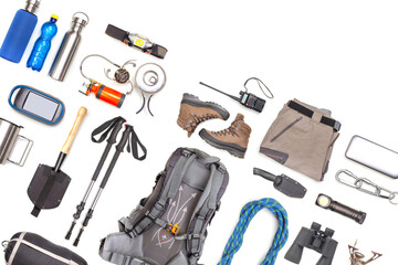 Set of tourist trekking items on white background. Top view of accessories for travel. Equipment for travel and hiking. Survival Items.