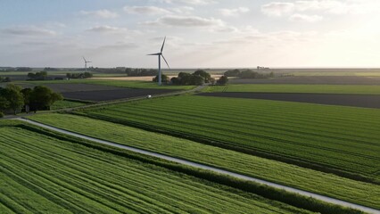 Picturesque rural landscape featuring a farm with wind turbines