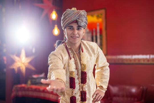young entrepreneur welcoming to his belly dance school dressed in arabic outfits