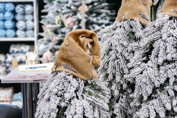 A Santee hat is placed on the tops of snow-covered fir trees.