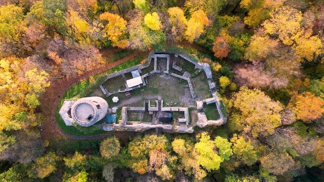 An aerial view of the beautiful ruins of Wlen Castle, in the town of Wlen, Lower Silesia in Poland, at the foot of the Karkonosze Mountains on the Bobr River, in autumn just before sunset.