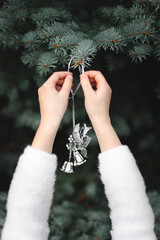 Girl Decorating a Pine Tree