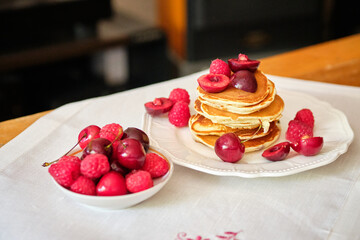 Pancakes withberries on a white napkin. Side view. Fritters.