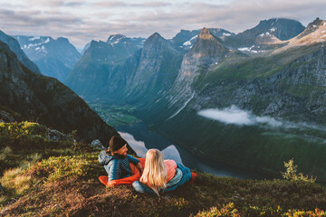 Couple in sleeping bags bivouac in mountains camping travel gear friends hiking in Norway, romantic...