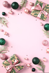 Pink Christmas background. Frame of gift boxes, Xmas balls, decorations. Happy New Year poster...