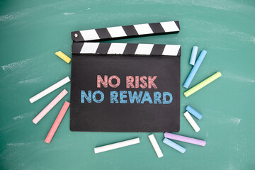 No Risk No Reward. Movie clapper and colored pieces of chalk