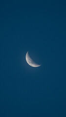 Obraz na płótnie Canvas waning moon in a blue sky