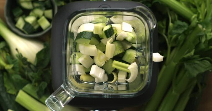 Top-Down Slow-Motion Capture: Fresh Cucumber and Celery Transforming into a Vibrant Green Smoothie