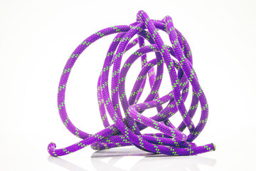 durable colored rope for climbing equipment on a white background. climbing rope. coil of braided cable. item for tourism and travel