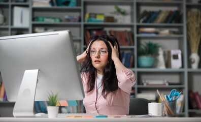 Angry woman screaming at pc computer in office