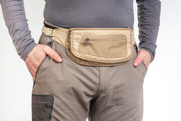 Male tourist with a waist bag for things and documents on a trip. belt bag with a zipper for things...