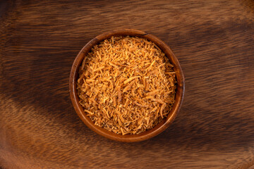 Grated coconut on wooden background.