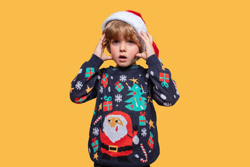 Emotional Christmas boy in a holiday clothes. Happy child . Happy New Year. Merry Christmas!
The child is waiting for the winter holidays. Boy shocked that winter holidays is coming.