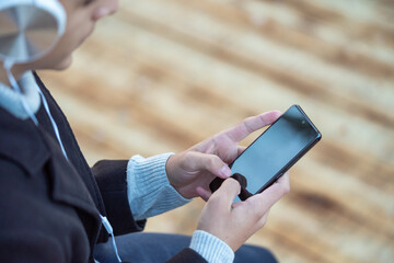 person using a mobile phone in the park