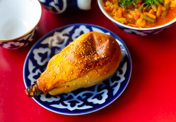 Popular Central Asian meat baked dish Samsa with lamb, sprinkled with sesame seeds on top