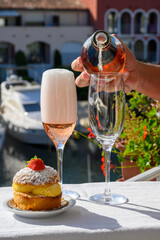 Summer party, drinking of French brut rose champagne sparkling wine in glasses in yacht harbour of Port Grimaud near Saint-Tropez, French Riviera vacation, France