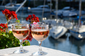 Glasses of cold rose Cote de Provence wine in yacht harbour of Port Grimaud, summer vacation on French Riviera in Provence, France