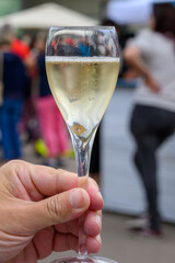 Tasting of sparkling white wine with bubbles champagne on summer festival route of champagne in Cote des Bar, Champagne region, France