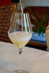Tasting of grand cru sparkling white wine with bubbles champagne by old champagne house in grand cru wine producer small village Ambonnay, Champagne, France
