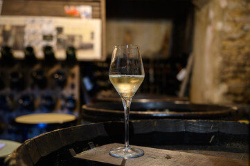 Tasting of grand cru sparkling white wine with bubbles champagne by old champagne caves in grand cru wine producer small village Cramant, Champagne, France