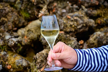 Tasting of sparkling white wine with bubbles champagne on summer festival route of champagne in Cote des Bar, Champagne region, France