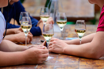 Tasting of sparkling white wine with bubbles champagne on summer festival route of champagne in Cote des Bar, Champagne region, France