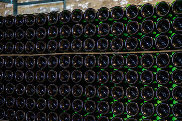 Many bottles of champagne sparkling wine. Visit of undergrounds caves, traditional producing of champagne wine in Cote des Bar, Aube, south of Champagne, France
