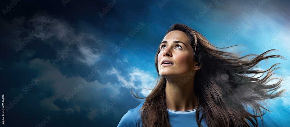 Fototapete a woman with flowing hair gazes up at the sky captivated by a digital banner displaying a graphic of