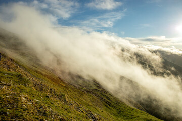 Clouds crossing the mountains of the port of Larrau between Spain and France in autumn and with warm light of dawn