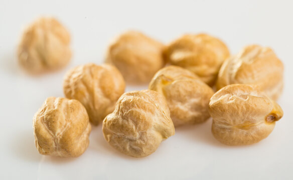 Chickpea seeds closeup on white surface. Organic food for healthy eating..