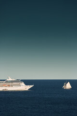 Monaco, vintage sail yacht and huge cruise liner are in sea at sunset, huge motor ship, wealth life...