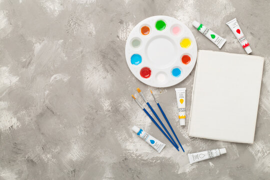 Painting tools on concrete background, top, view