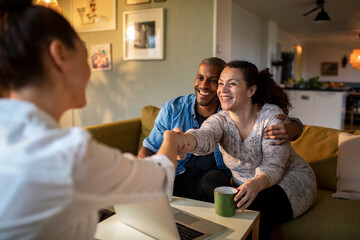 Happy couple settling differences with therapist at home