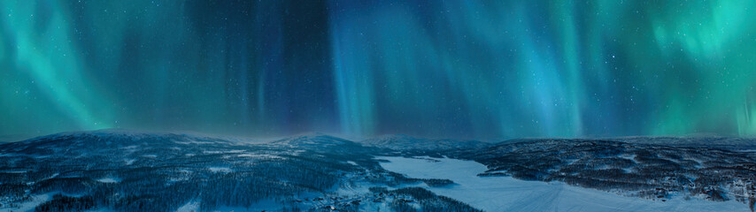Very wide scenic aerial night skies panorama on mountains winter forest, lake with snow mobile...