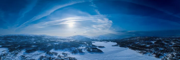 Foto op Aluminium Very wide scenic aerial panorama on frozen lake, mountains with snow mobile traces, sunny blue sky with arched plane traces, contrails. Scandinavian white winter landscape, Norway, Sweden © Alexandre Patchine