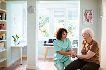Female nurse talking to a senior woman in the doctors office
