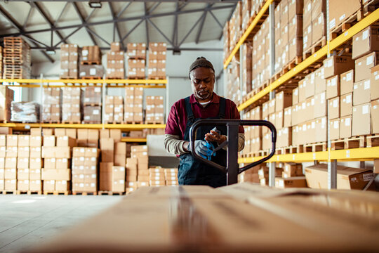 Warehouse Worker Organizing Boxes for Shipment