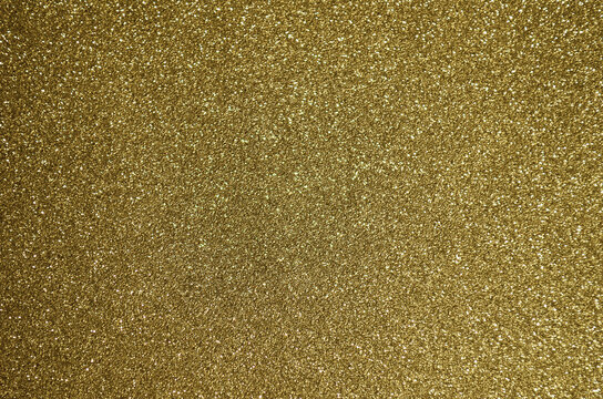 Fondo de brillos / textura glitter de color dorado/oro claro. Se puede usar como fondo de celebraci&oacute;n, a&ntilde;o nuevo o navidad.