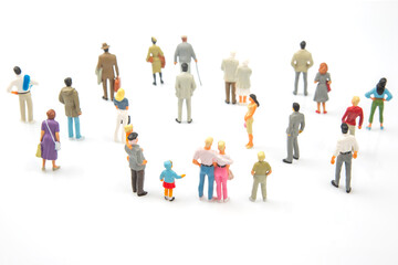 miniature people. group of different people communicate with each other on a white background. concept of communications and relations in society.