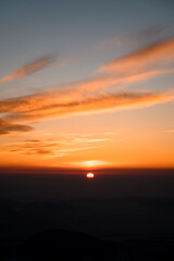 Beautiful bewitching view of sunset sun which lay down behind mountains and rocks