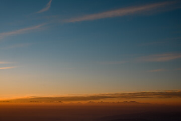 Amazing aerial view on mountain peaks during sunset. High mountain landscape in winter.