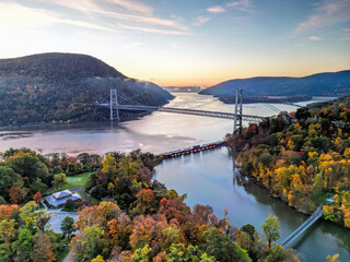 Aerial view of the Bear Mountain Bridge and Hudson River at sunrise in the fall
